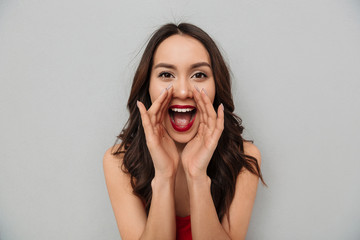 Sticker - Cheerful brunette woman in casual clothes screaming