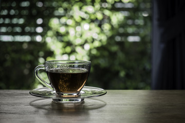 cup of tea near window with sun ray