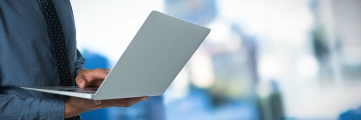 Poster - Composite image of mid-section of business man using a laptop