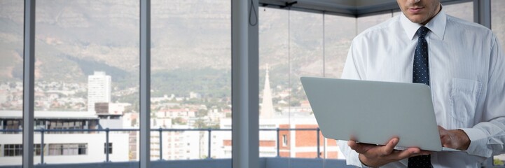 Poster - Composite image of business man using a laptop