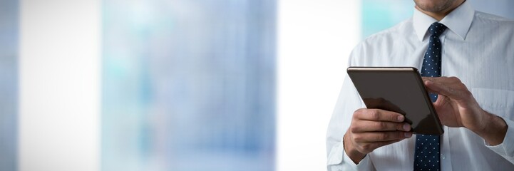 Poster - Composite image of upper mid-section of man using a tablet