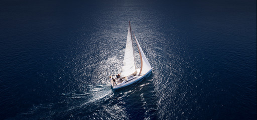 Amazing view to Yacht sailing in open sea at windy day. Drone view - birds eye angle.