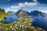 Fototapeta  - Reine, Lofoten, Norway. The village of Reine under a sunny, blue sky, with the typical rorbu houses. View from the top