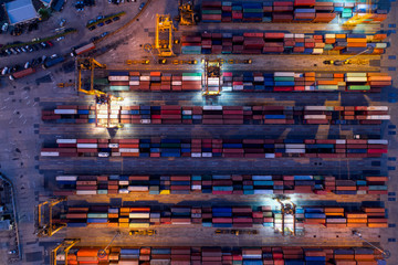 Aerial of containers yard in port congestion with ship vessels are loading and discharging operations of the transportation in international port.Shot from drone.