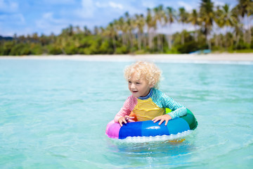 Wall Mural - Child on tropical beach. Sea vacation with kids.