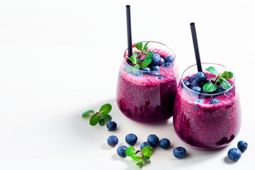 Freshly squeezed blueberry juice on the table. a healthy summer drink in two glasses.