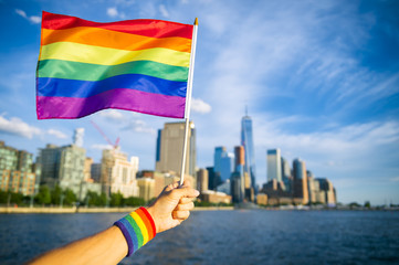 Wall Mural - banner,blue,city,colorful,equality,flag,freedom,friendship,hand,lesbian,lgbt,love,male,new york,nyc,pride,rainbow,sky,skyline,summer,sweatband,symbol,waving,wind