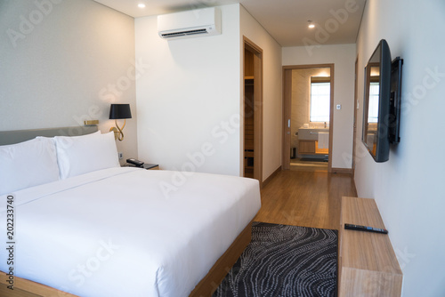 Small Hotel Room Interior With Double Bed And Bathroom