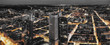 High quality black and white aerial panoramic view of Frankfurt, Germany at dusk. Yellow street traffic lights between the buildings.