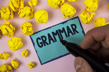 Poster - Word writing text Grammar. Business concept for System and Structure of a Language Correct Proper Writing Rules written by Man on Sticky note paper holding Marker plain background Paper Balls.