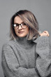 © Dmytro Flisak - Fashion woman in eyeglasses wearing stylish grey sweater