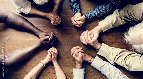 Cuadros en Lienzo Group of interlocked fingers praying together