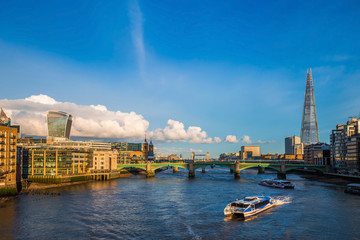 Wall Mural - London, England - Sightseeing boats at sunset on River Thames with Southwark Bridge and Tower Bridge and skyscrapers at background