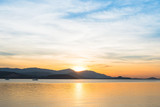 Fototapeta  - Beautiful sunrise and sunset with blue clouds over horizon clam blue sea and mountain background in morning and evening.