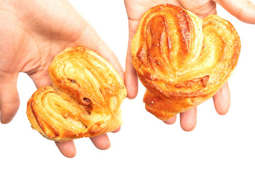 Sticker - Buns with raisins in a hand on a white background