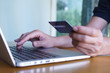 © nopparat - Man's hands holding credit card and typing on the keyboard of laptop, onine shopping, online payment.