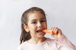 © kaganskaya115 - Happy little child girl eating fresh vegetables. Isolated portrait on white background. Healthy teeth.