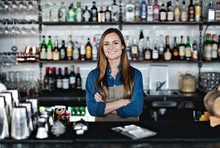 Portrait Of Woman Standing Behind Bar