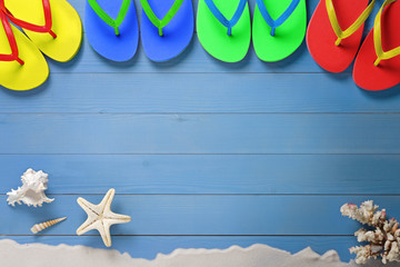 Wall Mural - Summer, multicolored flip flops on wooden floor