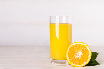 Canvas Print - glass of orange juice on a table