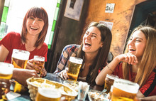 Happy Girlfriends Women Group Drinking Beer At Brewery Bar Restaurant - Friendship Concept With Young Female Friends Enjoying Time And Having Genuine Fun At Cool Vintage Pub - Focus On Left Girl