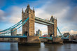 © zgphotography - London, England - Iconic Tower Bridge with traditional red double-decker bus and skyscrapers of Bank District at background