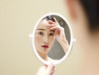 © imtmphoto - young asian woman looking at self in mirror