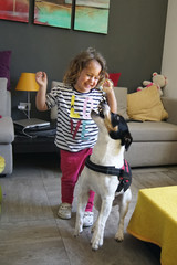 girl and dog playing with soap bubbles