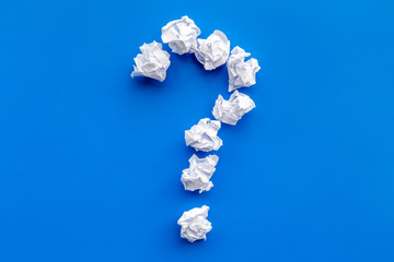Poster - Question mark lined with crumpled paper on blue background top view copy space