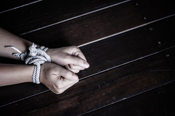 Wall Mural - Closeup woman hands were tied with a rope. Violence, Terrified, Human Rights Day concept.