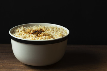 A bowl of instant noodles on wooden background