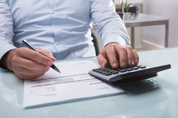 Businessperson Calculating Invoice