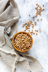 Wall Mural - Dry chickpeas in a wooden bowl and linen cloth.