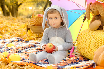 Sticker - Cute little child wearing bunny costume in autumn park