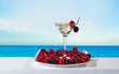 Glass of wine, cherries and sea