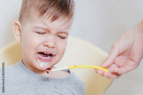 Fotografia, Obraz a little baby cries and refuses to eat