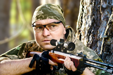 Wall Mural - young man with an air rifle