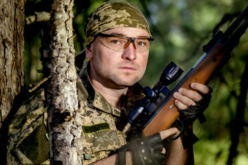 Wall Mural - young man with an air rifle