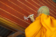 Buddhist ritual, the monk is writing the talisman on the wall to bless the new house.