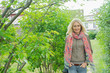 © PhotoAlto - Mature woman walking outdoors, smiling, portrait