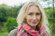 © PhotoAlto - Mature woman smiling outdoors, portrait