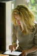 © PhotoAlto - Woman using digital tablet at home