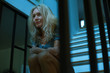 © PhotoAlto - Mature woman sitting on stairs, looking away in thought