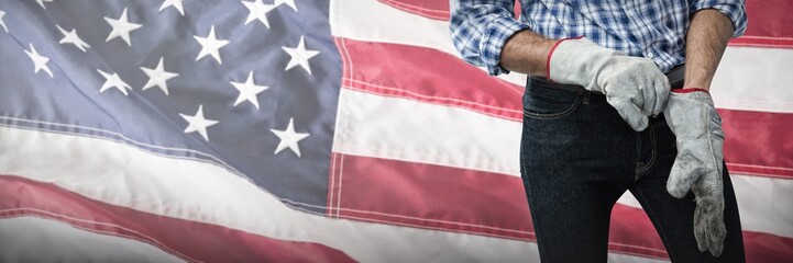 Wall Mural - Composite image of worker putting on working gloves