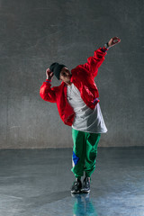 Young beautiful male dancer posing in studio