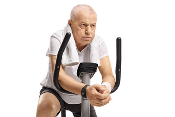 Sticker - Exhausted senior on an exercise bike