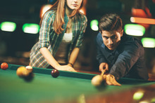 Young Couple Playing Pool