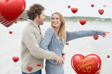 Side view of a relaxed romantic couple at beach against happy valentines day