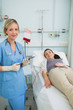 © WavebreakmediaMicro - Nurse standing next to a female patient