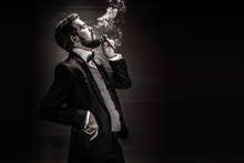 Portrait Of Bearded Smoking Cigar Gentleman In A Suit